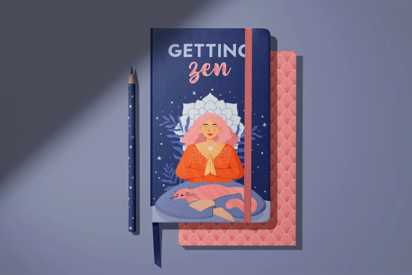 Notebook with a meditating woman and cat, beside a starry pencil